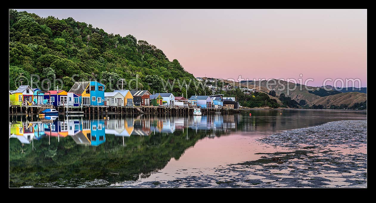 Image of Boatsheds at Mana on the Pauatahanui Arm Inlet of the Porirua Harbour, with boats on moorings. Evening twilight. Panorama, Paremata, Porirua City District, Wellington Region, New Zealand (NZ) stock photo image