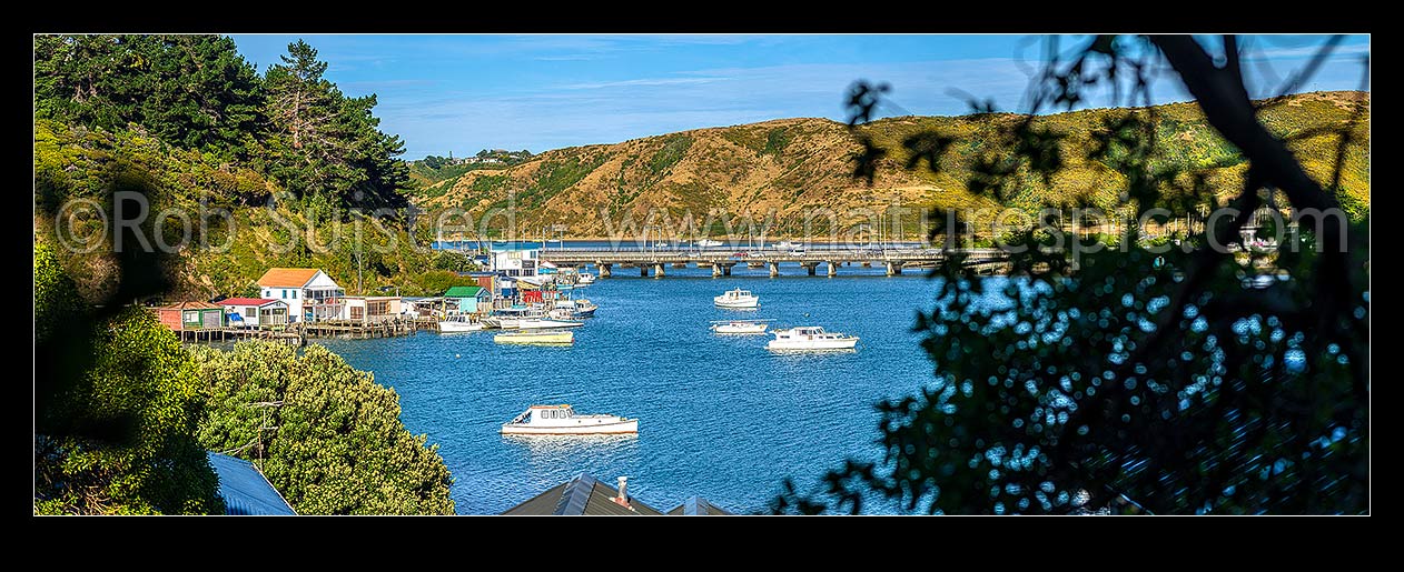 Image of Porirua Harbour with boats moored and boatsheds in Ivey Bay, Pauatahanui Arm. SH1 and railway bridges centre. Panorama, Paremata, Porirua City District, Wellington Region, New Zealand (NZ) stock photo image