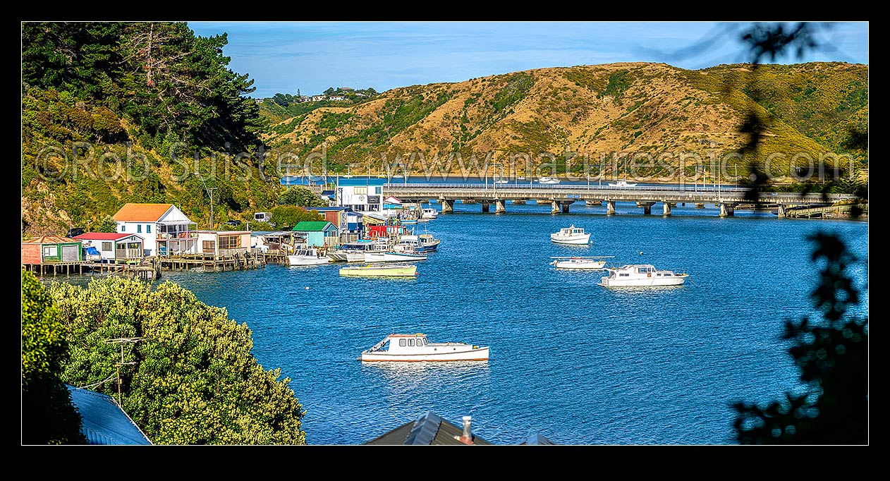 Image of Porirua Harbour with boats moored and boatsheds in Ivey Bay, Pauatahanui Arm. SH1 and railway bridges centre. Panorama, Paremata, Porirua City District, Wellington Region, New Zealand (NZ) stock photo image