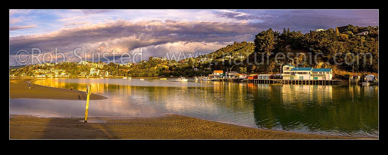 Image of Paremata boatsheds and moored vessels at Ivey Bay on Pauatahanui Inlet Arm of Porirua Harbour. Panorama, Paremata, Porirua City District, Wellington Region, New Zealand (NZ) stock photo image