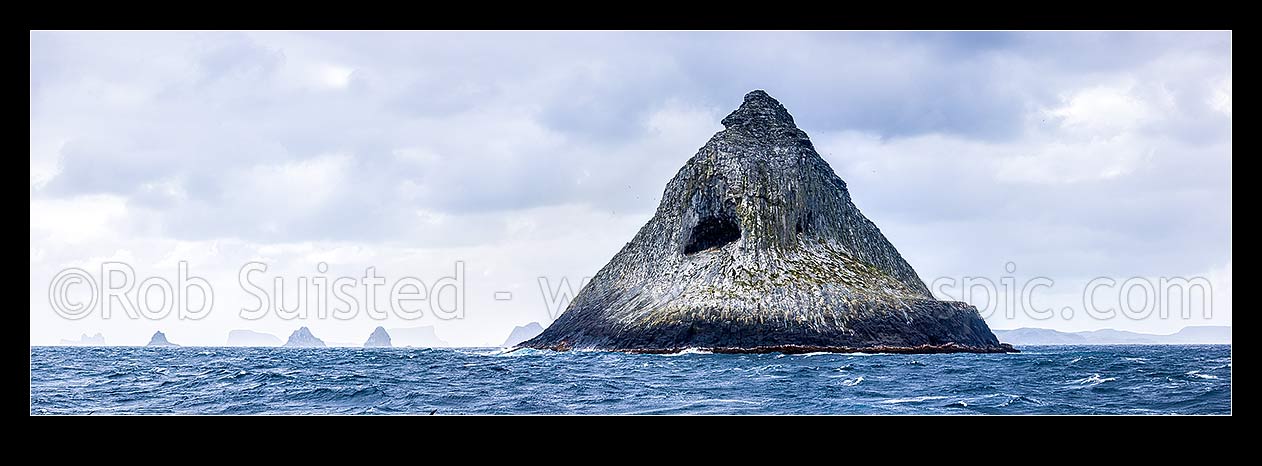 Image of The Pyramid (Tarakoikoia) island, basalt outcrop, with reefs and islands of The Castle, Little Mangere, Mangere and Pitt Island behind. Panorama, The Pyramid, Chatham Islands District, Chatham Islands Region, New Zealand (NZ) stock photo image