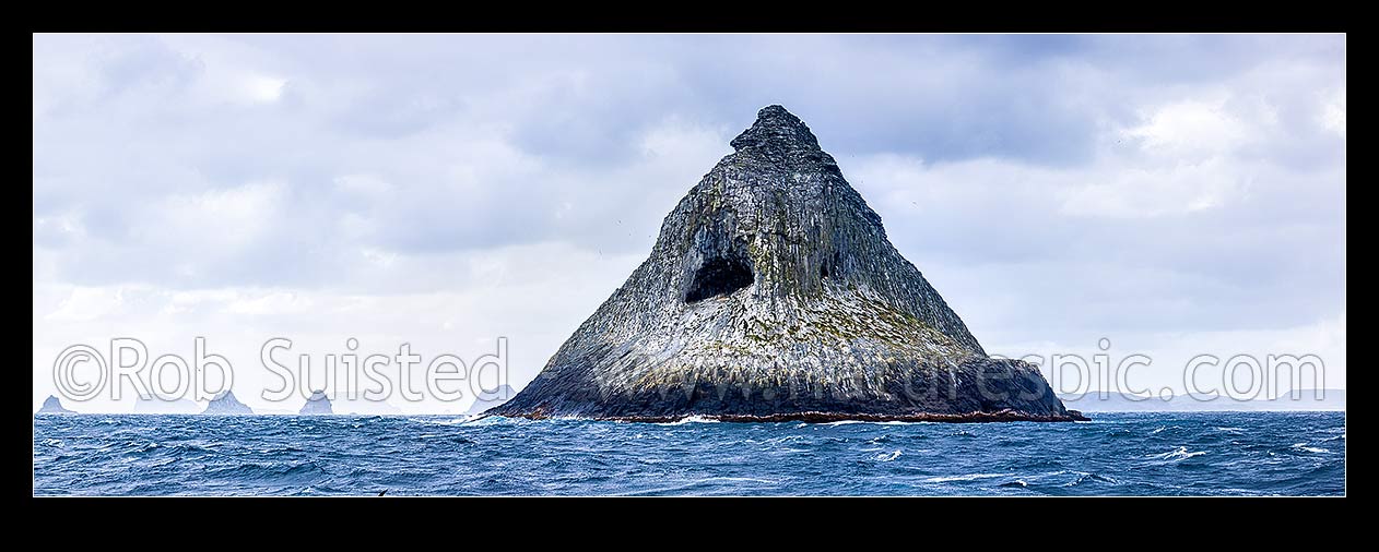 Image of The Pyramid (Tarakoikoia) island, basalt outcrop, with reefs and islands of The Castle, Little Mangere, Mangere and Pitt Island behind. Panorama, The Pyramid, Chatham Islands District, Chatham Islands Region, New Zealand (NZ) stock photo image