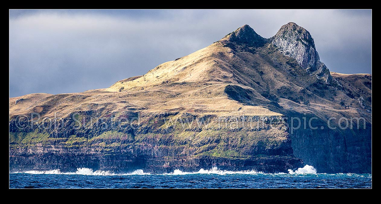 Image of The Horns, Te Whakahewa, prominent diorite columns prominent at Cape L'Eveque at southern end of Chatham Island, and 100m high seacliffs pounded by sea. Panorama, Chatham Islands Rekohu, Chatham Islands District, Chatham Islands Region, New Zealand (NZ) stock photo image