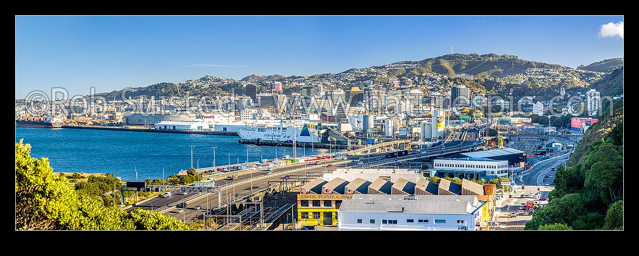 Image of Wellington gateway through Kaiwharawhara and Thorndon. Wellington Motorway and rail corridor entering Wellington City from the north, Port at left. Panorama, Kaiwharawhara, Wellington City District, Wellington Region, New Zealand (NZ) stock photo image