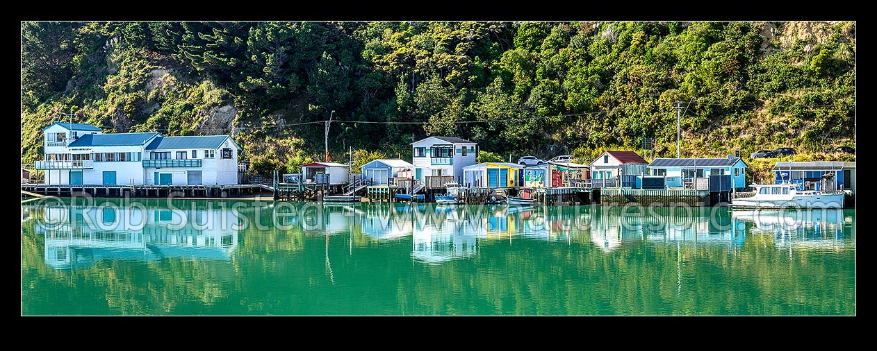 Image of Paremata boatsheds and boating club reflected at Ivey Bay on the Pauatahanui Inlet arm of Porirua Harbour. Panorama, Paremata, Porirua City District, Wellington Region, New Zealand (NZ) stock photo image