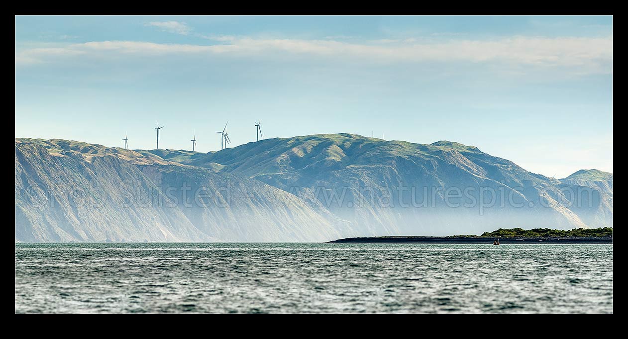 Image of Porirua west coast, looking past Shingle Point Mana Island and 'The Bridge' towards Pipinui Point and Makara. Mill Creek wind farm. Panorama, Titahi Bay, Porirua City District, Wellington Region, New Zealand (NZ) stock photo image