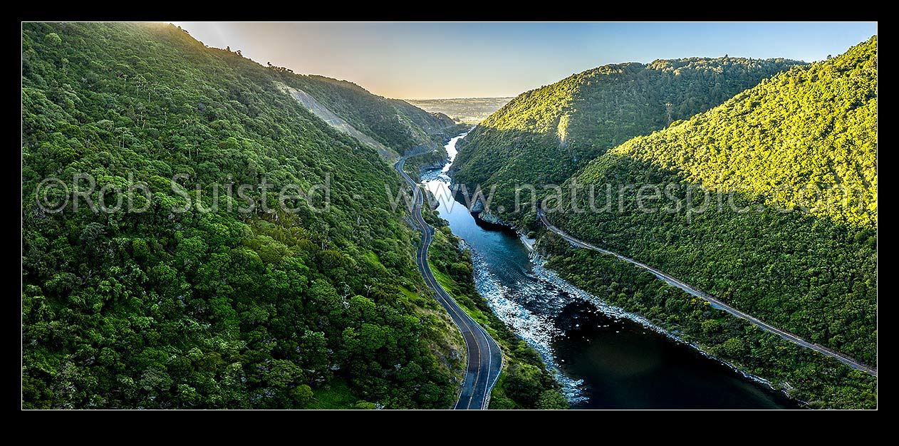 Image of Manawatu River passing through Manawatu Gorge and Scenic Reserve in evening light. Aerial panorama over railway and the now disused highway. Looking East, Ashhurst, Palmerston North City District, Manawatu-Wanganui Region, New Zealand (NZ) stock photo image