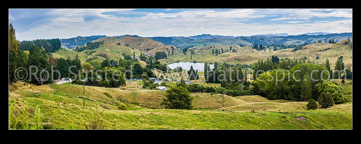 Image of Tiniroto village with Lake Rotokaha behind, on Tiniroto Road, inland Poverty Bay rural farming district. Panorama, Tiniroto, Gisborne District, Gisborne Region, New Zealand (NZ) stock photo image