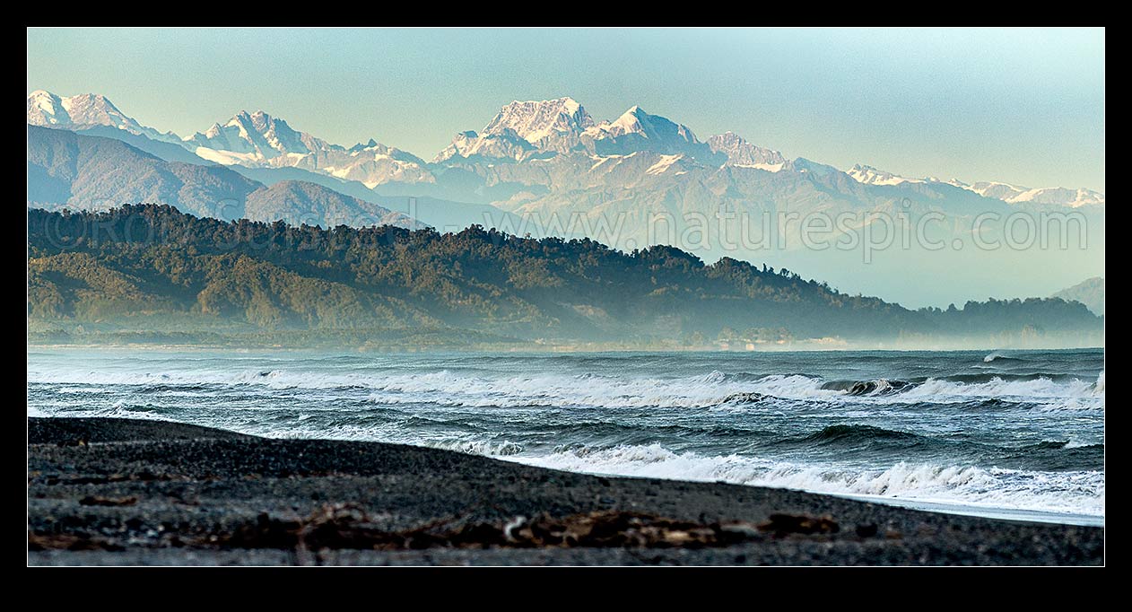 Image of Southern Alps Main Divide above Westland beach near Hokitika, at dawn. Aoraki Mt Cook (3754m) and Mt Tasman (3497m) centre. Panorama, Hokitika, Westland District, West Coast Region, New Zealand (NZ) stock photo image