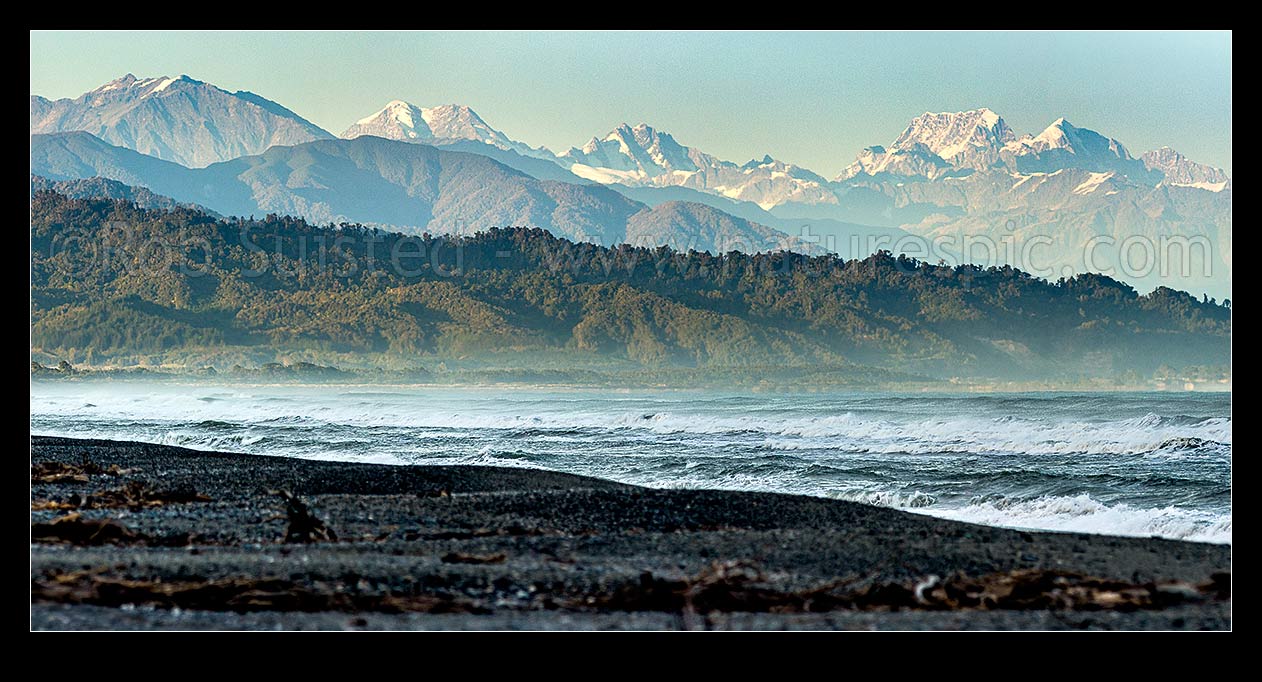 Image of Southern Alps Main Divide above Westland beach near Hokitika, at dawn. Mt Adams (2208m) far left, Elie De Beaumont, Minarets and Aoraki Mt Cook (3754m) and Mt Tasman (3497m) right. Panorama, Hokitika, Westland District, West Coast Region, New Zealand (NZ) stock photo image