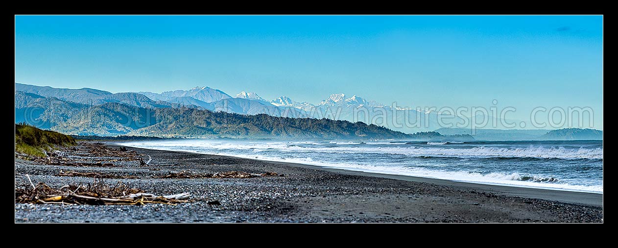 Image of Southern Alps Main Divide above Westland beach near Hokitika, at dawn. Aoraki Mt Cook (3754m) and Mt Tasman (3497m) centre right, Mt Adams (2208m) left. Panorama, Hokitika, Westland District, West Coast Region, New Zealand (NZ) stock photo image