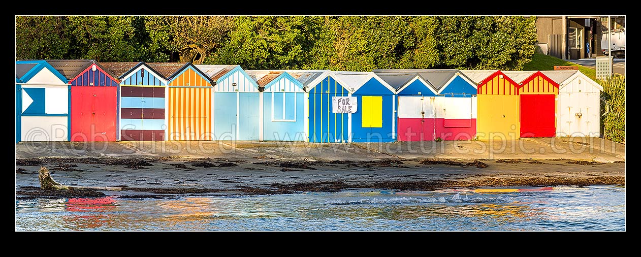 Image of Titahi Bay Beach boat sheds, a colourful brightly painted iconic feature of the bay. Panorama, Titahi Bay, Porirua City District, Wellington Region, New Zealand (NZ) stock photo image