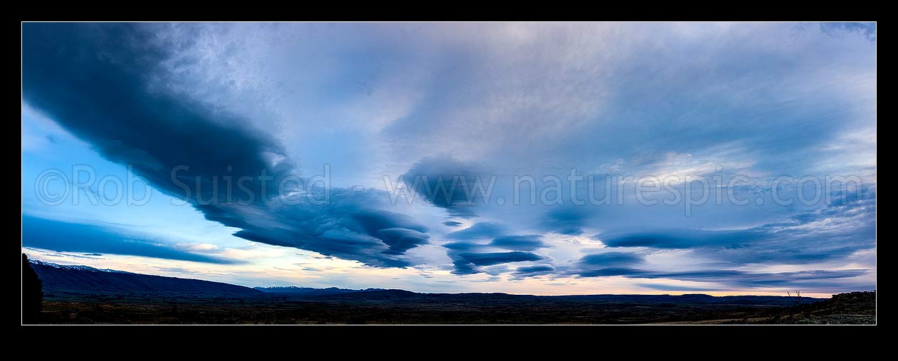 Image of Clouds over Central Otago. Moody dramatic lenticular clouds at dawn. Panorama, Middlemarch, Central Otago District, Otago Region, New Zealand (NZ) stock photo image