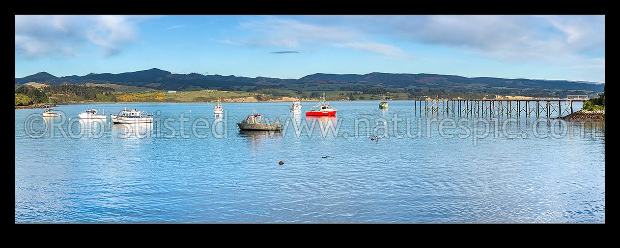 Image of Moeraki fishing fleet vessels moored in Onekakara Bay on a calm morning. Panorama, Moeraki, Waitaki District, Canterbury Region, New Zealand (NZ) stock photo image