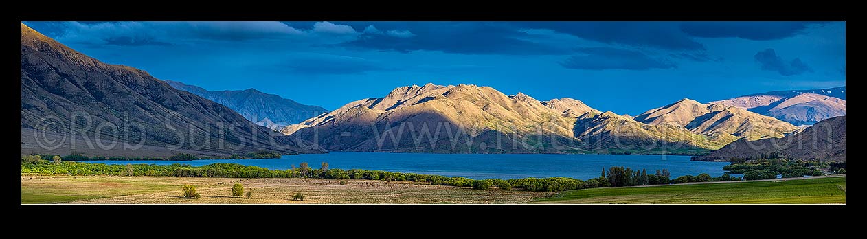 Image of Lake Benmore in evening light. St Marys Range far right. Moody panorama, Otematata, MacKenzie District, Canterbury Region, New Zealand (NZ) stock photo image