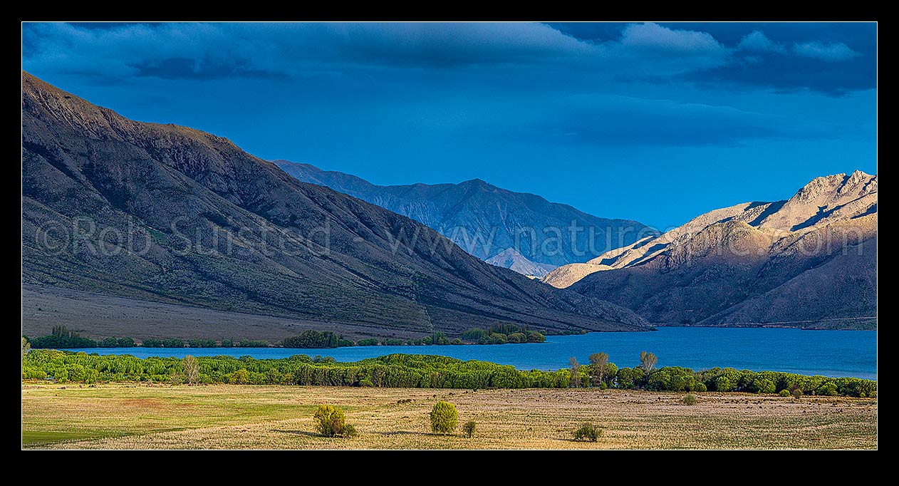 Image of Lake Benmore in evening light. St Marys Range far right. Moody panorama, Omarama, MacKenzie District, Canterbury Region, New Zealand (NZ) stock photo image