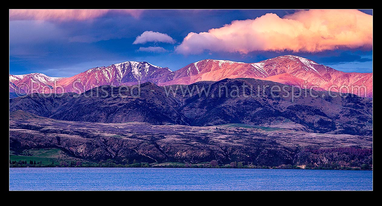 Image of Lake Aviemore with the sunlit Kirkliston Range above. High country panorama at sunset, Otematata, MacKenzie District, Canterbury Region, New Zealand (NZ) stock photo image