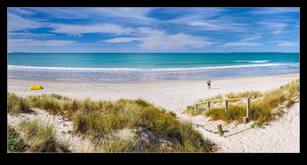 Image of Papamoa Beach. Looking over the white sand beach and sand dune access path on a sunny blue sky day towards Motiti Island. Panorama, Papamoa Beach, Tauranga District, Bay of Plenty Region, New Zealand (NZ) stock photo image