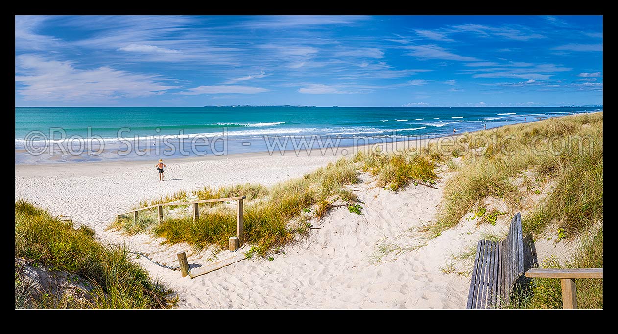 Image of Papamoa Beach. Looking over the white sand beach and sand dune access path on a sunny blue sky day towards Motiti Island. Panorama, Papamoa Beach, Tauranga District, Bay of Plenty Region, New Zealand (NZ) stock photo image