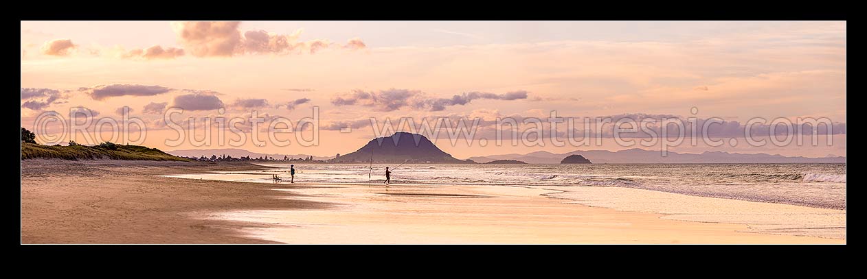 Image of Papamoa Beach evening twilight looking west towards Mt Maunganui Mauao (231m). People surfcasting fishing on golden beach. Panorama, Papamoa Beach, Tauranga District, Bay of Plenty Region, New Zealand (NZ) stock photo image