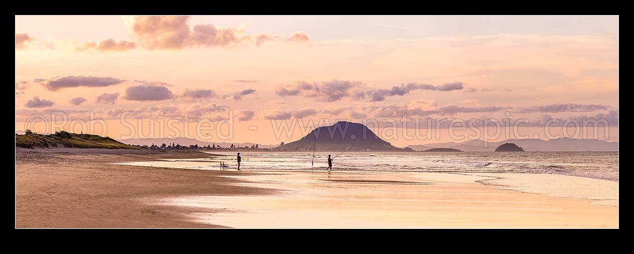 Image of Papamoa Beach evening twilight looking west towards Mt Maunganui Mauao (231m). People surfcasting fishing on golden beach. Panorama, Papamoa Beach, Tauranga District, Bay of Plenty Region, New Zealand (NZ) stock photo image