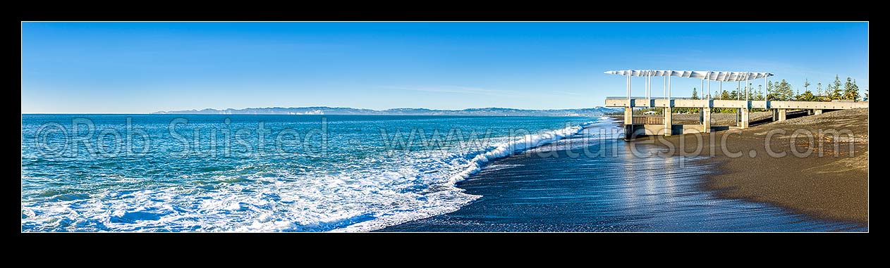 Image of Napier foreshore with viewing platform and marine outfall in early morning light. Clifton and Cape Kidnappers coast beyond. Panorama, Napier, Napier City District, Hawke's Bay Region, New Zealand (NZ) stock photo image