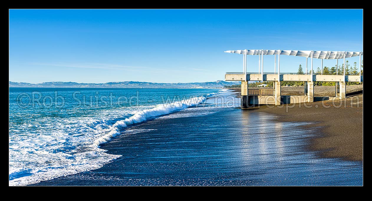 Image of Napier foreshore with viewing platform and marine outfall in early morning light. Clifton and Cape Kidnappers coast beyond. Panorama, Napier, Napier City District, Hawke's Bay Region, New Zealand (NZ) stock photo image