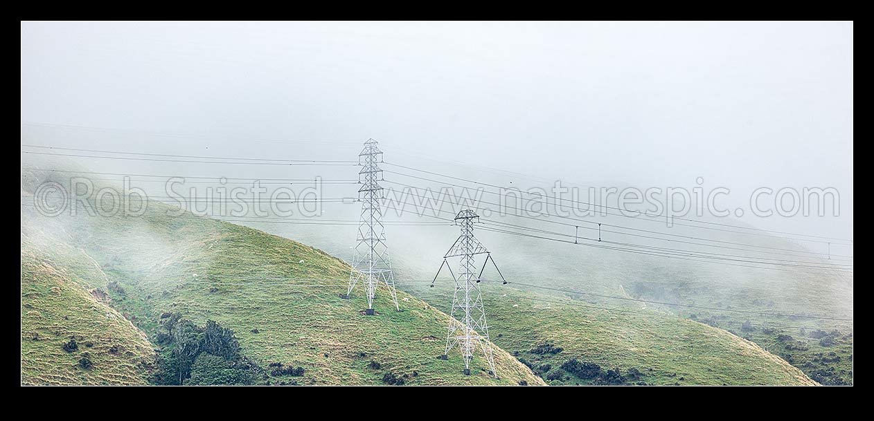 Image of High voltage transmission power lines and pylons over misty farmland. HVDC link Oteranga Bay - Haywards A OTB-HAY-A at left, Takapu Road - Wilton A right, Churton Park, Wellington City District, Wellington Region, New Zealand (NZ) stock photo image