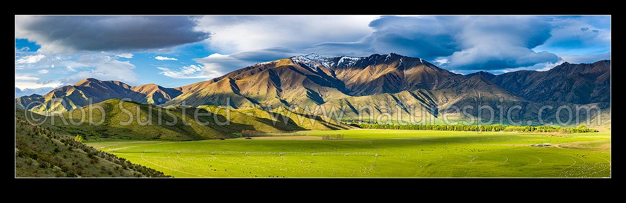 Image of Farmland and high country of the Benmore Range and Totara Peak (1822m above). Including dairy farmland and pivot irrigators. Panorama, Omarama, MacKenzie District, Canterbury Region, New Zealand (NZ) stock photo image