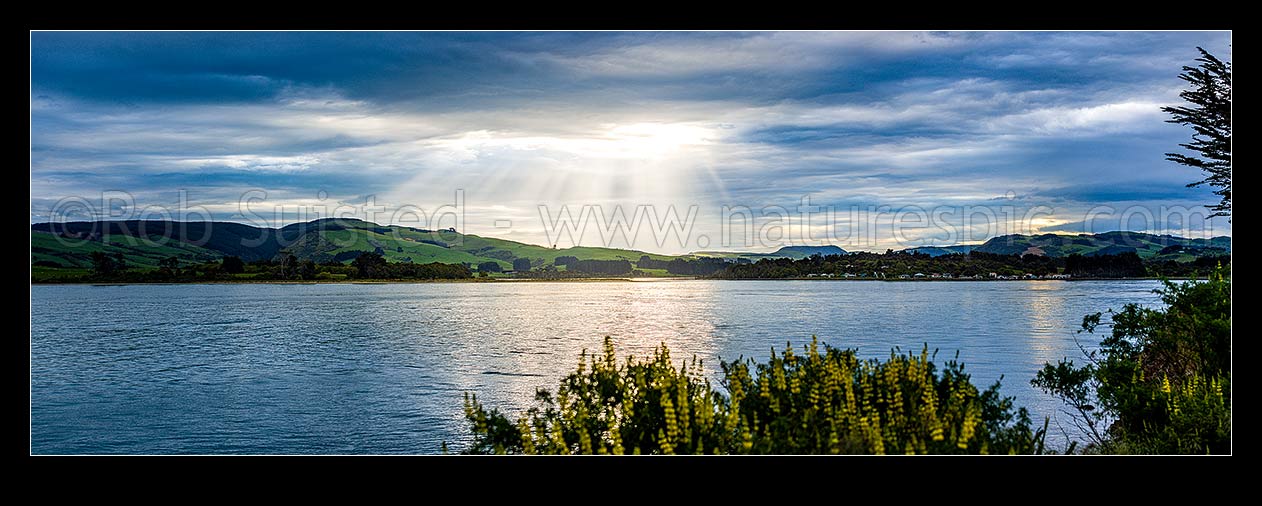 Image of Catlins River mouth at Surat Bay and New Haven, with sunrays over the inlet. Panorama, Catlins, Clutha District, Otago Region, New Zealand (NZ) stock photo image