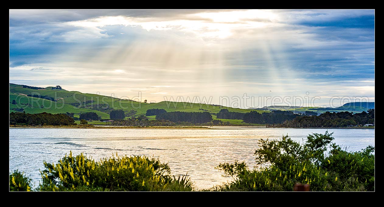 Image of Catlins River mouth at Surat Bay and New Haven, with sunrays over the inlet. Panorama, Catlins, Clutha District, Otago Region, New Zealand (NZ) stock photo image