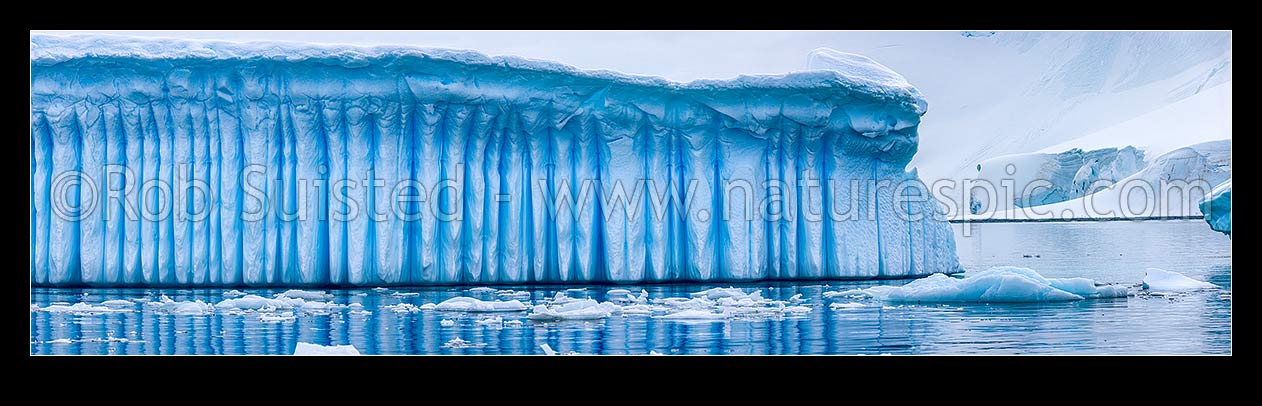 Image of Iceberg in Antarctica showing vertical striations pattern caused by melt air bubble fluting. Polar panorama, Antarctic Peninsula, Antarctica Region, New Zealand (NZ) stock photo image