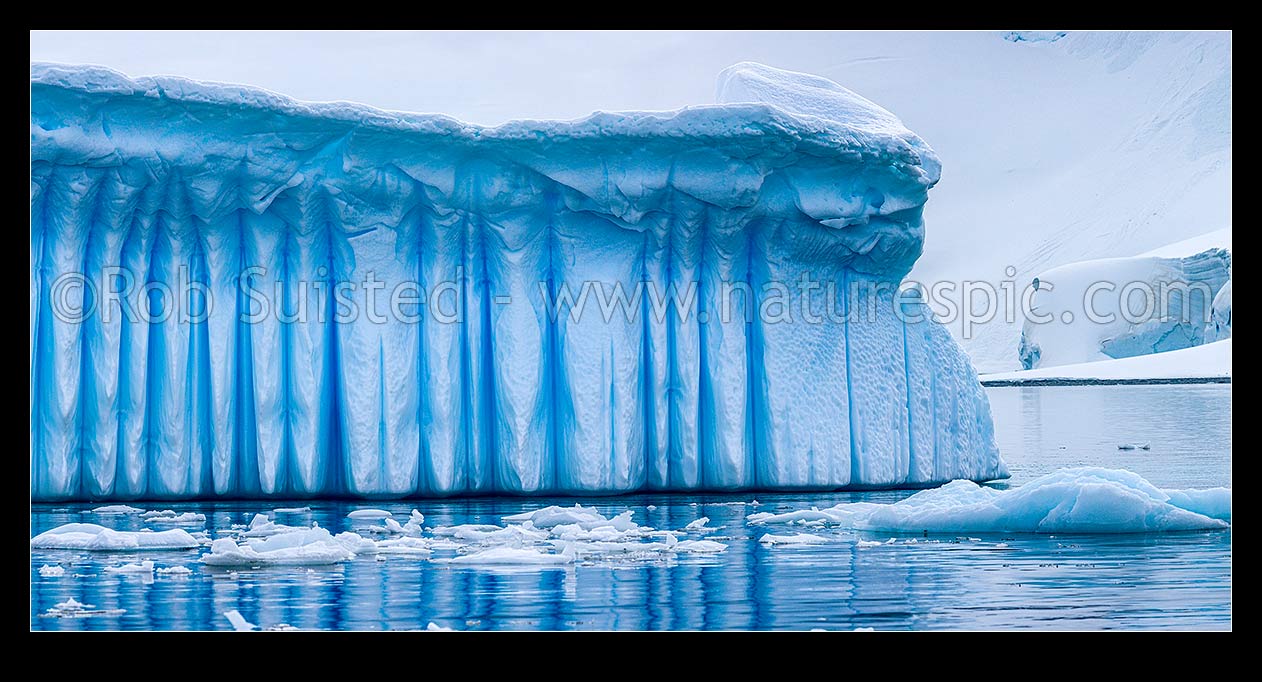 Image of Iceberg in Antarctica showing vertical striations pattern caused by melt air bubble fluting. Polar panorama, Antarctic Peninsula, Antarctica Region, New Zealand (NZ) stock photo image