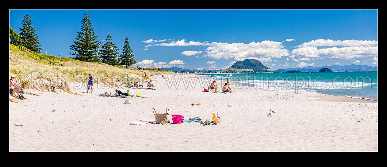 Image of Papamoa Beach on a summer day with people enjoying the summer sunshine. Looking west towards Mt Maunganui Mauao (231m). Panorama, Papamoa Beach, Tauranga District, Bay of Plenty Region, New Zealand (NZ) stock photo image